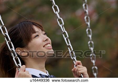 High school girl on a swing View Large Photo Image Stock Photograph - High school girl on a swing. Fotosearch