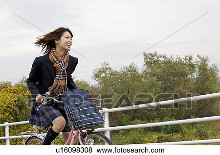 High school girl riding a bicycle View Large Photo Image Stock Photo - High school girl riding a bicycle. Fotosearch