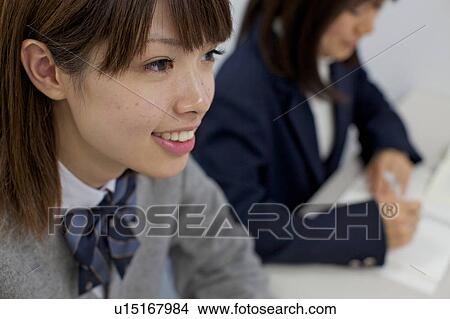 Picture - High school girl studying at school. Fotosearch