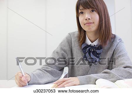 Stock Image - High school girl studying at school. Fotosearch
