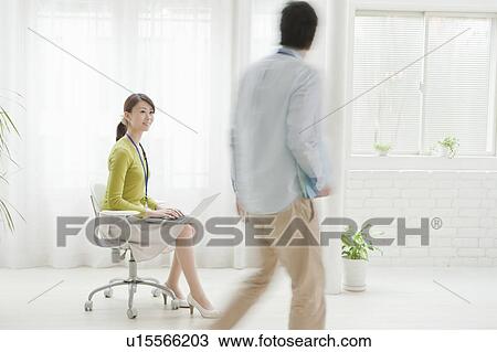 Man Passing Woman with Laptop View Large Photo Image Stock Image - Man Passing Woman with Laptop. Fotosearch