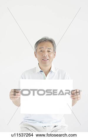 Picture - Mature Man Holding Blank Message. Fotosearch