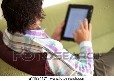 Mature man using a digital tablet View Large Photo Image Stock Image - Mature man using a digital tablet. Fotosearch