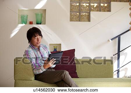 Mature man using a digital tablet View Large Photo Image Stock Image - Mature man using a digital tablet. Fotosearch