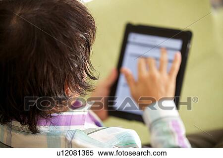 Mature man using a digital tablet View Large Photo Image Stock Photography - Mature man using a digital tablet. Fotosearch