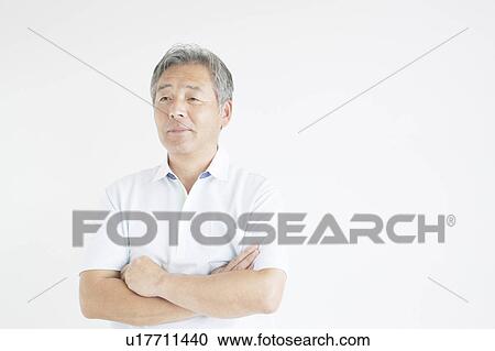Stock Image - Mature man with arms crossed. Fotosearch