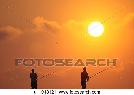 Stock Image - Men fishing at dawn, Chiba Prefecture, Japan. Fotosearch