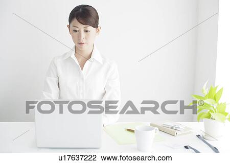 Stock Image - Mid Adult Businesswoman Working. Fotosearch
