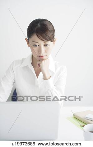 Stock Photograph - Mid Adult Businesswoman Working. Fotosearch