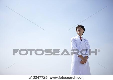 Mid Adult Doctor Against Blue Sky View Large Photo Image Stock Photography - Mid Adult Doctor Against Blue Sky. Fotosearch