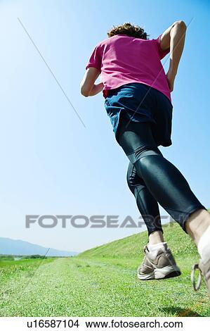 Picture - Mid Adult Man Jogging. Fotosearch