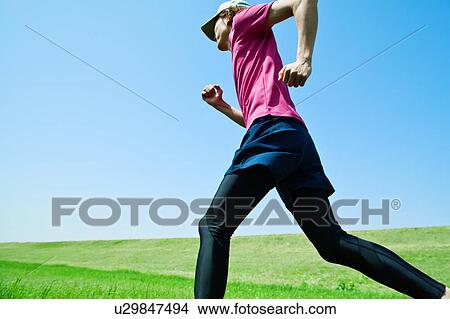 Picture - Mid Adult Man Jogging. Fotosearch