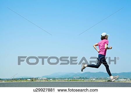 Stock Image - Mid Adult Man Jogging. Fotosearch