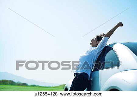 Mid Adult Man Leaning Against Car View Large Photo Image Stock Photo - Mid Adult Man Leaning Against Car. Fotosearch
