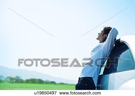 Mid Adult Man Leaning Against Car View Large Photo Image Stock Photo - Mid Adult Man Leaning Against Car. Fotosearch