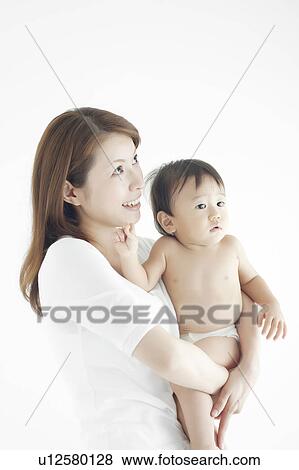 Stock Photo - Mother and Baby Boy Looking Up. Fotosearch