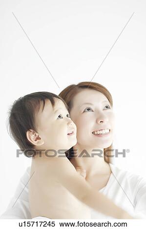 Stock Photography - Mother and Baby Boy Looking Up. Fotosearch