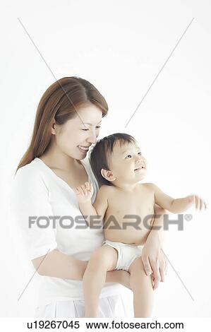 Stock Photography - Mother and Baby Boy Looking Up. Fotosearch