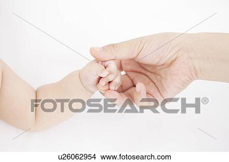Picture - Mother and baby holding hands. Fotosearch