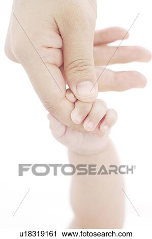 Stock Image - Mother and baby holding hands. Fotosearch