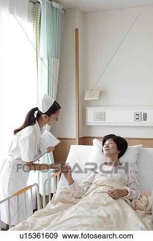Stock Photo - Nurse Caring For Female Patient. Fotosearch