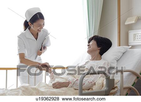 Nurse Caring For Female Patient View Large Photo Image Stock Photo - Nurse Caring For Female Patient. Fotosearch