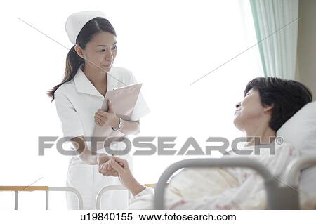 Stock Photography - Nurse Holding Patient's Hand. Fotosearch