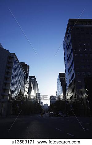 Stock Image - Office buildings at dawn, Chiyoda Ward, Tokyo Prefecture, Honshu, Japan. Fotosearch