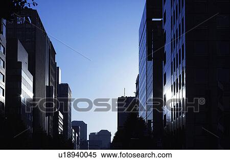 Stock Photography - Office buildings at dawn, Chiyoda Ward, Tokyo Prefecture, Honshu, Japan. Fotosearch
