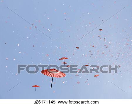 Paper umbrella and petals blowing in the wind View Large Photo Image Stock Photography - Paper umbrella and petals blowing in the wind. Fotosearch