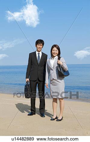 Stock Photo - Portrait of business people at beach . Fotosearch