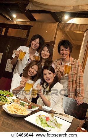 Portrait of friends at a bar View Large Photo Image Picture - Portrait of friends at a bar. Fotosearch