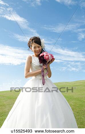Stock Image - Portrait of young woman in wedding dress. Fotosearch