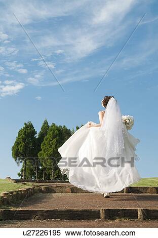 Stock Photography - Rear view of young woman in wedding dress. Fotosearch