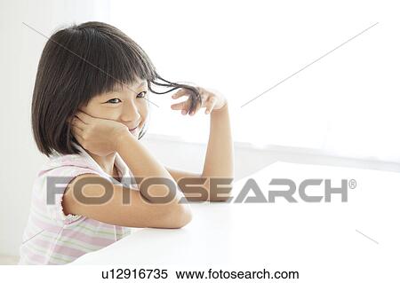 Stock Photography - School Girl with Hand in Hair. Fotosearch