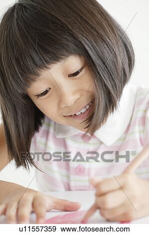 Stock Photo - Schoolgirl Studying. Fotosearch