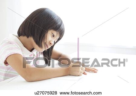 Stock Photo - Schoolgirl Writing. Fotosearch