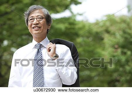Senior businessman holding jacket View Large Photo Image Stock Image - Senior businessman holding jacket. Fotosearch