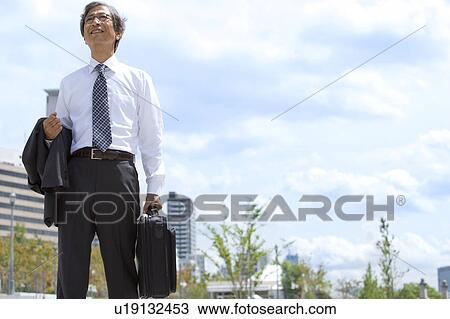 Stock Image - Senior businessman standing. Fotosearch