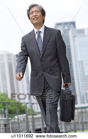 Senior businessman walking View Large Photo Image Stock Image - Senior businessman walking. Fotosearch