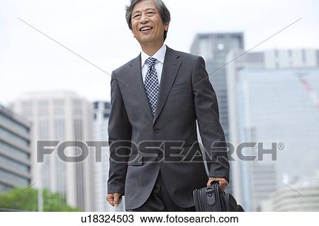 Stock Image - Senior businessman walking. Fotosearch