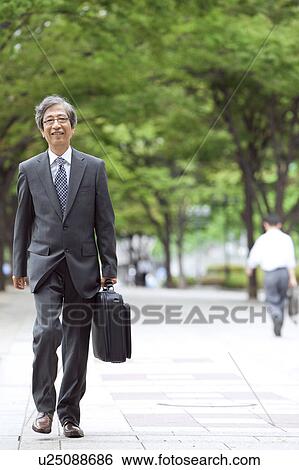Senior businessman walking View Large Photo Image Stock Photograph - Senior businessman walking. Fotosearch