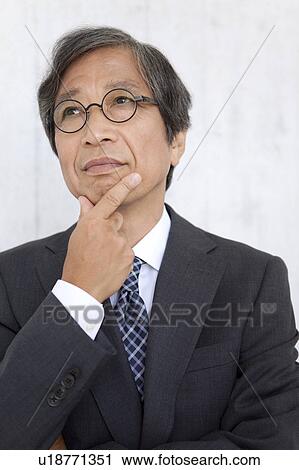 Senior businessman with hand on chin View Large Photo Image Stock Image - Senior businessman with hand on chin. Fotosearch