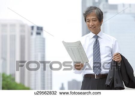Stock Image - Senior businessman with newspaper. Fotosearch