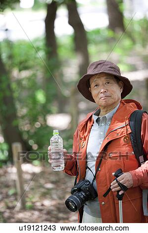 Senior man holding bottled water View Large Photo Image Stock Image - Senior man holding bottled water. Fotosearch