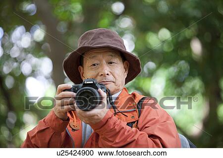 Senior man with camera View Large Photo Image Stock Image - Senior man with camera. Fotosearch