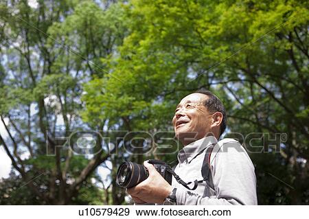 Senior man with camera View Large Photo Image Stock Photo - Senior man with camera. Fotosearch