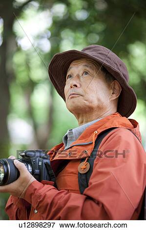 Senior man with camera View Large Photo Image Stock Photo - Senior man with camera. Fotosearch
