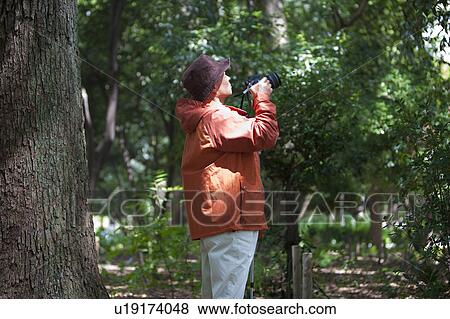 Senior man with camera View Large Photo Image Stock Photo - Senior man with camera. Fotosearch
