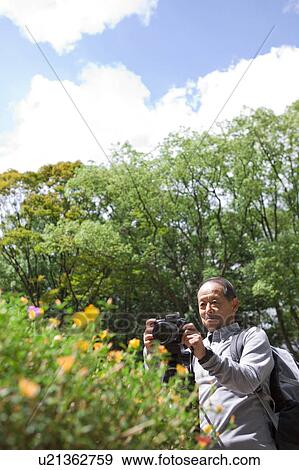 Senior man with camera View Large Photo Image Stock Photo - Senior man with camera. Fotosearch